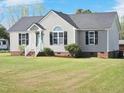 Beautifully maintained home with light siding, black shutters, complemented by a lush green lawn at 105 Seminole Dr, Wendell, NC 27591
