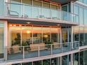 A large terrace with outdoor seating offers stunning sunset views and a seamless indoor/outdoor living experience at 110 N Corcoran St # 2302, Durham, NC 27701