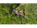 Aerial view of a secluded home surrounded by dense, vibrant green forest, offering privacy and a connection with nature at 111 Standing Rock Rd, Chapel Hill, NC 27516