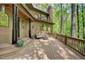 Inviting deck with outdoor seating, complemented by the natural beauty of the surrounding forest and tranquil setting at 111 Standing Rock Rd, Chapel Hill, NC 27516