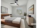 Bright bedroom features a ceiling fan, plush rug, and ample natural light through a window at 117 Pierce Rd, Garner, NC 27529