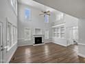 Bright living room with high ceilings, fireplace, built-in shelves, with wood flooring at 117 Pierce Rd, Garner, NC 27529
