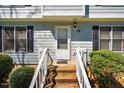 Welcoming front entrance with brick steps, white railings, and neat landscaping at 121 Westview Dr # 43, Carrboro, NC 27510