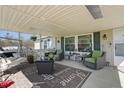 Inviting porch features comfortable seating, a ceiling fan, and a 'Welcome Home' sign at 122 Blueberry Dr, Selma, NC 27576