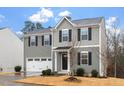 Two-story home with gray siding and a white garage door at 1423 Bridgewater Dr, Durham, NC 27704