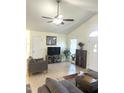 Bright living room featuring tile flooring, ceiling fan, and ample seating at 1721 Daniels Farm Rd, Mebane, NC 27302