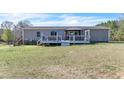 The home's backyard features a charming deck with gazebo, perfect for entertaining at 174 Dirgie Mine Rd, Roxboro, NC 27574