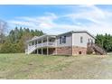 A charming home featuring a covered front porch and steps to a back deck at 174 Dirgie Mine Rd, Roxboro, NC 27574