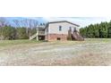 Rear view of home with a covered porch and stairs to a back deck and yard at 174 Dirgie Mine Rd, Roxboro, NC 27574