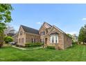 Brick home featuring manicured lawn, mature landscaping, and an architectural roof line at 1808 Pattersons Mill Rd, Durham, NC 27703