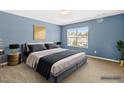 Calming primary bedroom with a blue accent wall, king bed, and side tables at 2 Bolter Ct, Durham, NC 27704