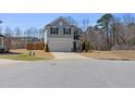 View of the attractive two-story home featuring a two-car garage and a well-maintained lawn at 2040 Water Marsh Trl, Fuquay Varina, NC 27526