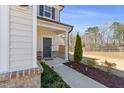 Inviting front door with decorative details, a landscaped walkway, and the house number clearly visible at 2040 Water Marsh Trl, Fuquay Varina, NC 27526