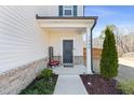Charming front porch with decorative accents and a well-manicured garden bed at 2040 Water Marsh Trl, Fuquay Varina, NC 27526
