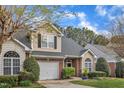 View of a beautiful townhome with a one car garage and a well manicured green lawn at 2043 White Pond Ct, Apex, NC 27523