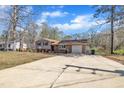 Expansive driveway leads to a well-maintained home with a blend of brick and siding and an attached garage at 215 Longview Dr, Smithfield, NC 27577
