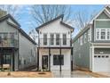 Charming two-story new home with a balcony and modern design elements, framed by neighboring houses at 2212 Edwin Ave # A, Durham, NC 27705