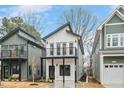 Charming two-story new home with a balcony and modern design elements, framed by neighboring houses at 2212 Edwin Ave # A, Durham, NC 27705