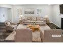 Bright living room featuring neutral furniture, stylish decor, and ample natural light streaming through the windows at 23 Round Spring Ln, Durham, NC 27712