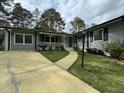 A charming single-story home with a well-maintained lawn and inviting walkway to the front door at 2616 Firelight Rd, Raleigh, NC 27610