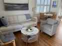 Well-lit living room with hardwood floors, a neutral color palette, and cozy seating arrangements at 2706 Mcneil St St, Raleigh, NC 27608