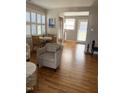 Inviting living room featuring hardwood floors, a comfortable chair and a dining area bathed in natural light at 2706 Mcneil St St, Raleigh, NC 27608