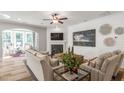 Cozy living room with fireplace, shiplap accent wall, and large windows for ample natural light at 307 Augusta Pond Way # 167, Raleigh, NC 27603