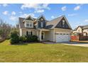 Beautiful two-story home with a well-manicured lawn, and convenient two-car garage at 36 Deep Woods Ln, Cameron, NC 28326