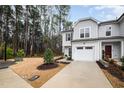 Inviting two-story home featuring gray siding, a one-car garage, and a well-maintained front lawn with shrubbery at 4220 Congleton Pl, Durham, NC 27703
