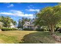 Landscaped front yard featuring a two-story home with a charming front porch beneath blue skies at 4516 Ocean Crest Cir, Raleigh, NC 27603