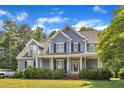 Charming two-story home with a welcoming front porch and beautifully manicured landscaping at 4516 Ocean Crest Cir, Raleigh, NC 27603