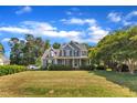 Expansive front lawn showcases a blue two-story home with inviting front porch and lush greenery at 4516 Ocean Crest Cir, Raleigh, NC 27603