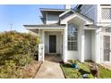 Exterior of building showcasing entrance with plants and greenery at 4911 Hollenden Dr # 208, Raleigh, NC 27616