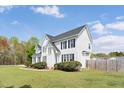 The side view shows the home's design and landscaping, set against a clear sky at 5745 Spence Farm Rd, Holly Springs, NC 27540