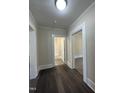 Hallway with freshly painted walls and flooring leads to bathroom and other rooms at 602 Dexter St, Rocky Mount, NC 27803