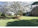 Beautiful brick home with large front yard and mature blossoming trees at 6521 Vintage Ridge Ln, Fuquay Varina, NC 27526