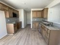 Modern kitchen with light wood cabinets, granite countertops and stainless steel microwave at 74 Harvest Hills Ln, Dunn, NC 28334