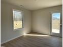 Sunny living area with lots of light and a door leading to the outside at 74 Harvest Hills Ln, Dunn, NC 28334