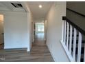 Inviting entryway with hardwood floors leading into a spacious open-concept living area at 779 Old Station Pointe, Angier, NC 27501