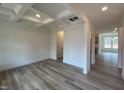 Bright living room boasting a coffered ceiling and hardwood floors, perfect for entertaining at 779 Old Station Pointe, Angier, NC 27501