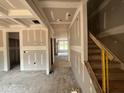 Spacious living room with under-construction coffered ceilings and an open layout at 779 Old Station Pointe, Angier, NC 27501