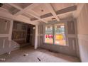 Bright living room with under-construction coffered ceiling and lots of natural light at 779 Old Station Pointe, Angier, NC 27501