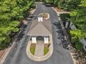 Aerial view of the community entrance featuring well-manicured landscaping and mature trees at 85 Christenbury Ln, Clayton, NC 27527