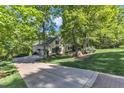Two-story home with a long driveway, lush greenery, and well-manicured lawn at 85 Christenbury Ln, Clayton, NC 27527