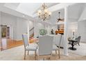 Elegant dining area with chandelier lighting, connecting to the living room and staircase at 1021 Reaves Dr Dr, Chapel Hill, NC 27516