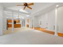 Open-concept living space with hardwood floors, skylights, and seamless flow to the kitchen at 1021 Reaves Dr Dr, Chapel Hill, NC 27516