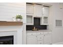 Living room features a marble fireplace, wet bar, and custom cabinets at 1023 Kelton Cottage Way, Morrisville, NC 27560