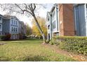 Well-maintained condo complex with mature trees, manicured lawns and gray siding at 1081 Wirewood Dr # 302, Raleigh, NC 27605