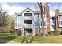 Exterior of condo showing balcony, gray siding, brick accents, and mature landscaping at 1081 Wirewood Dr # 302, Raleigh, NC 27605