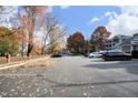 Parking lot with ample parking spaces and mature fall foliage at 1081 Wirewood Dr # 302, Raleigh, NC 27605